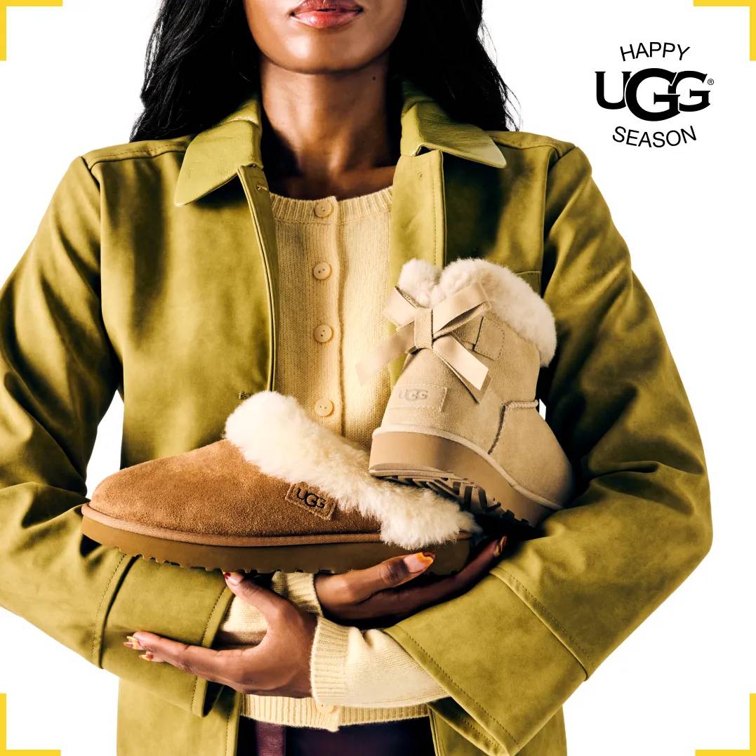 Featuring a woman holding an assortment of UGGs.