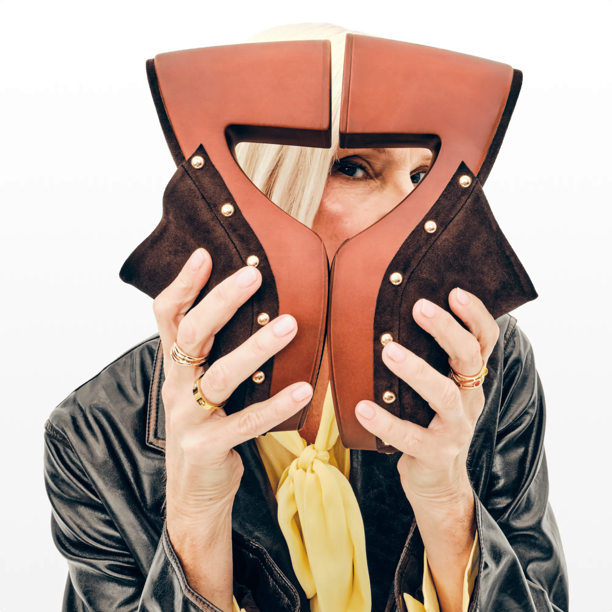 Featuring a woman holding a pair clogs.