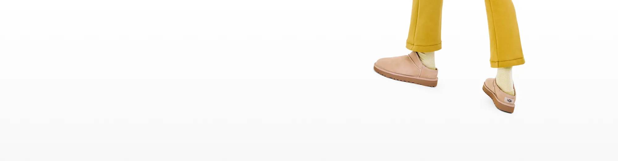 Featuring a pair of UGG slippers.