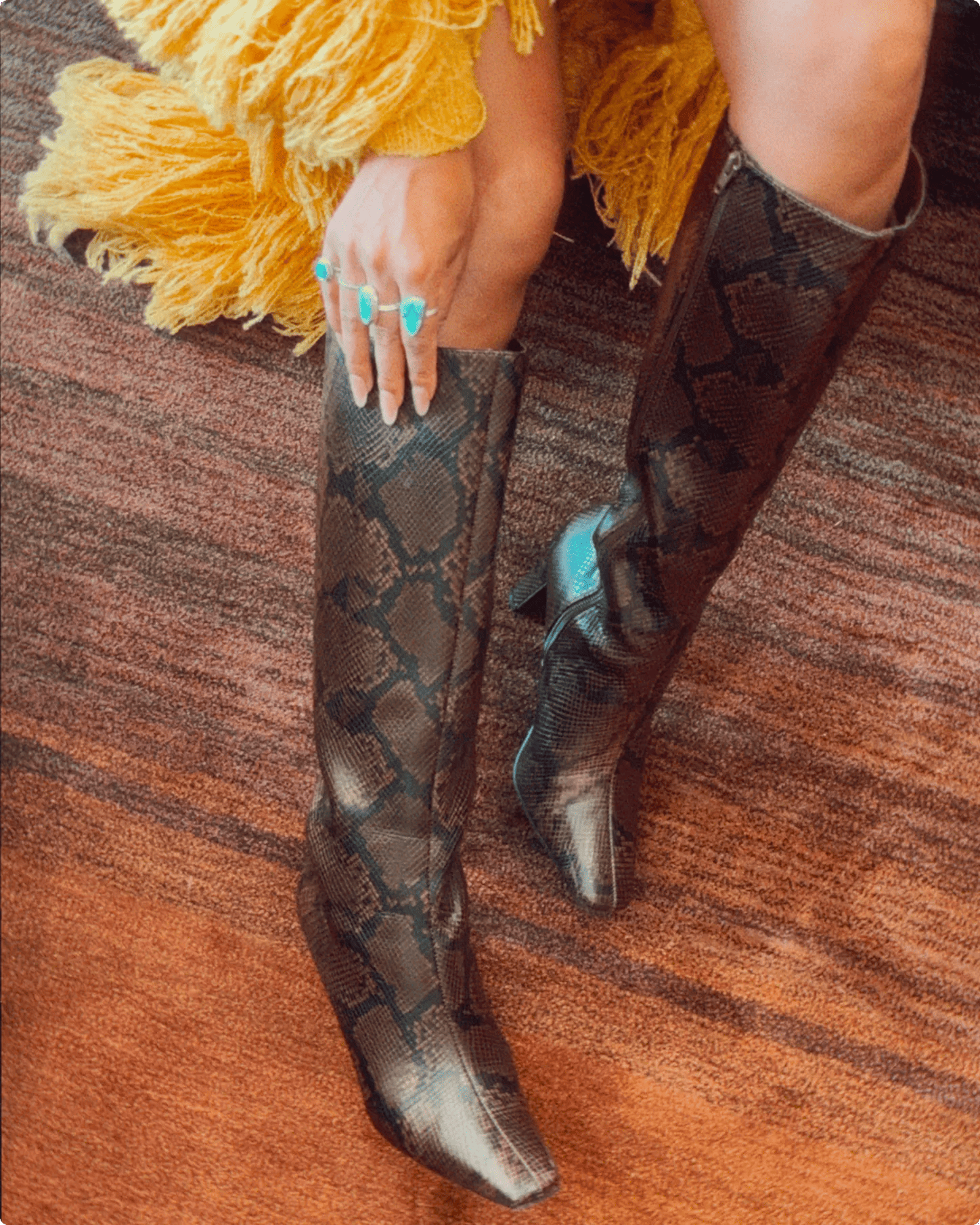 Featuring Serene Russel wearing a tall snakeskin boots.