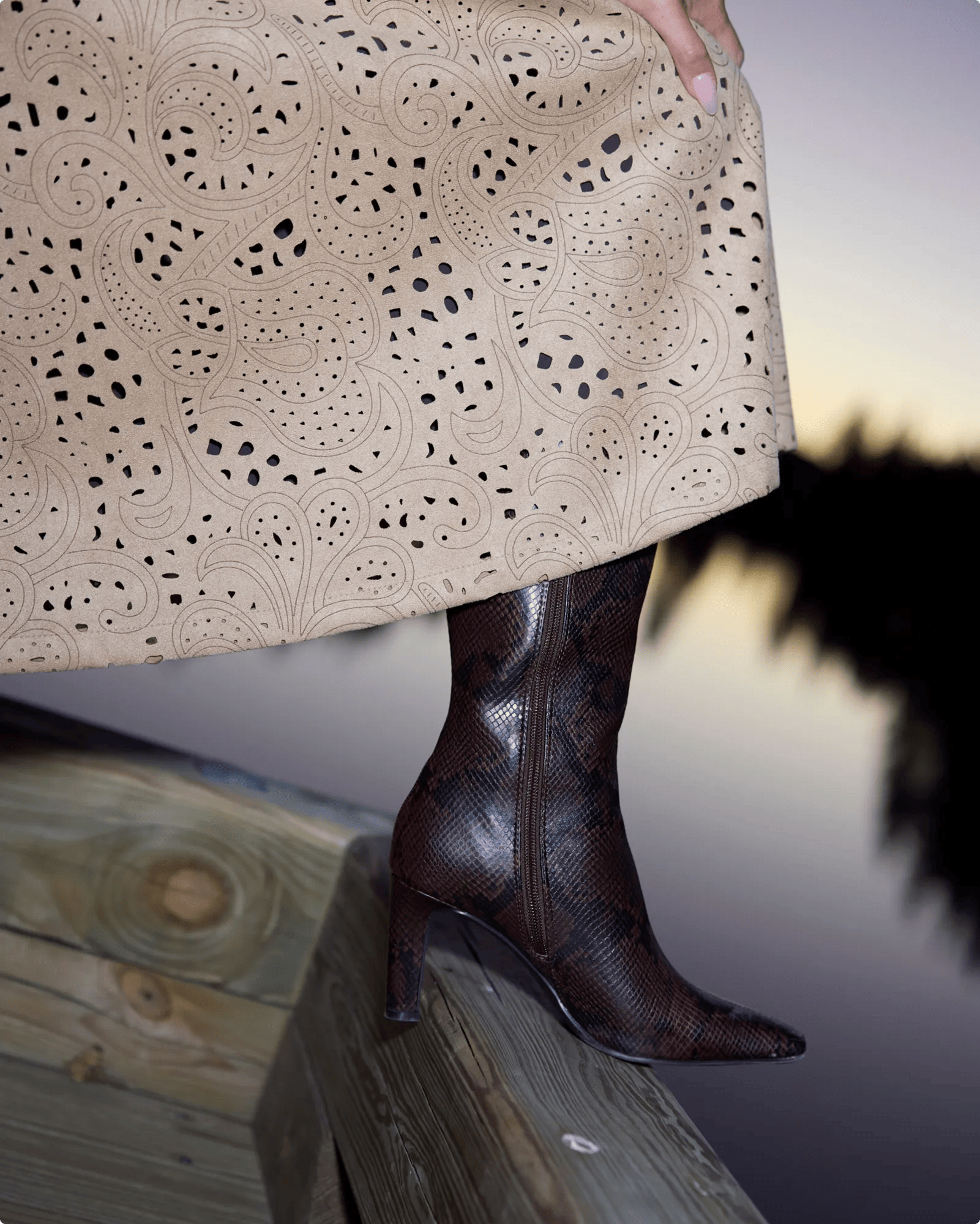 Featuring Barbarah William wearing snakeprint tall boots.