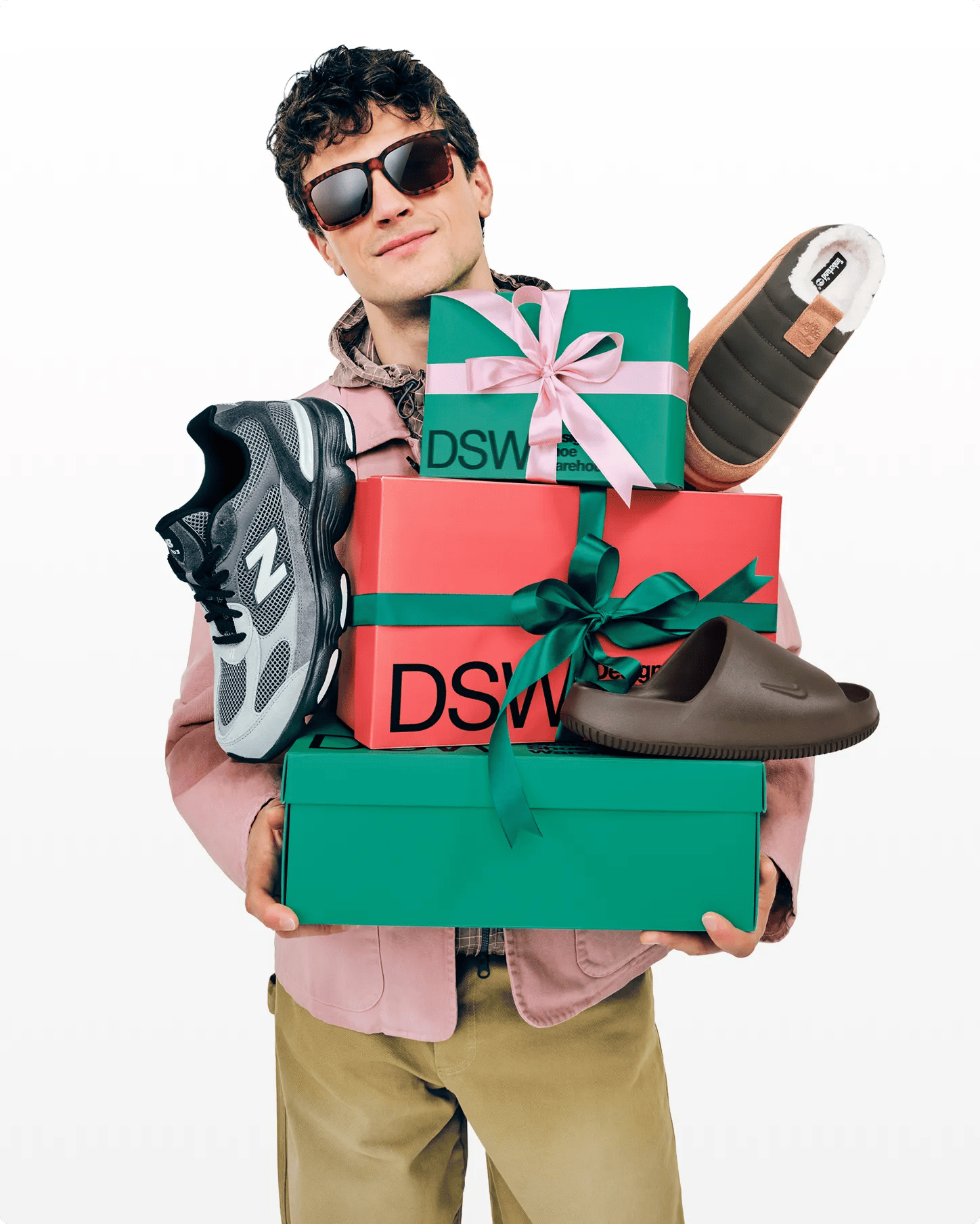 A man carrying a bunch of holiday gifts.