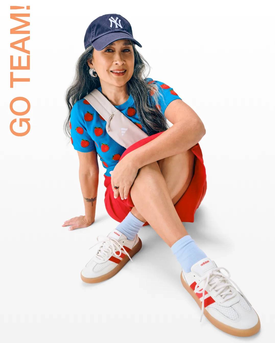 Featuriing a woman dressed for a sporting event.