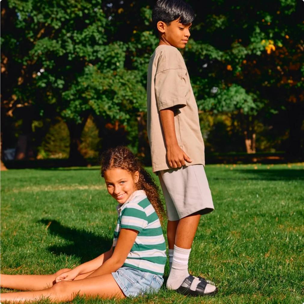Boy and girl in their Birkenstock sandals in a park
