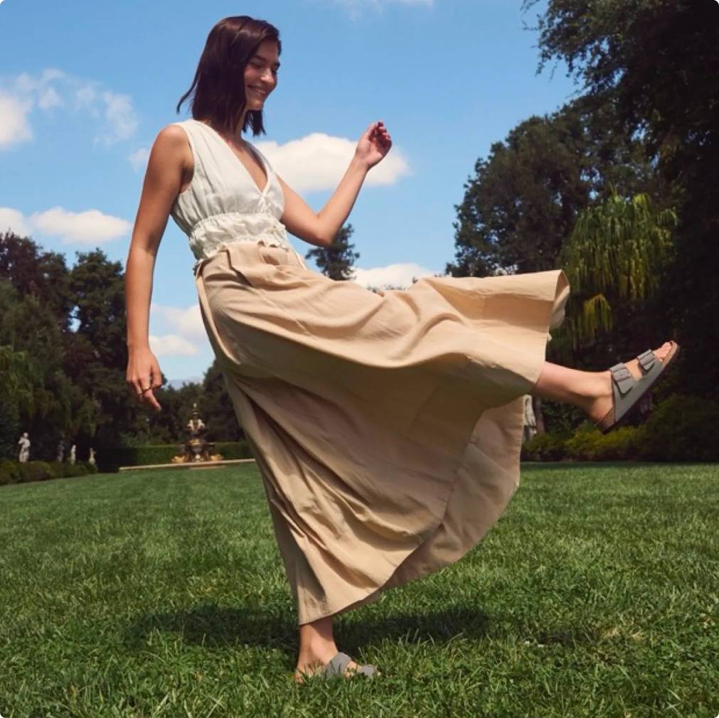 Woman showing off her Birkenstock sandals in a park
