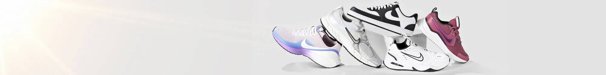 Variety of Nike sneakers stacked on each other