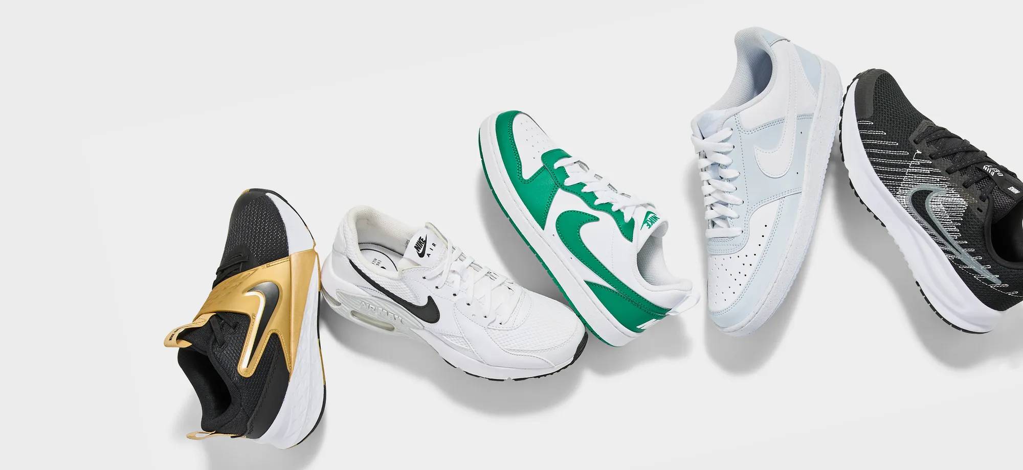 5 different coloured Nike sneakers stacked on top of each other
