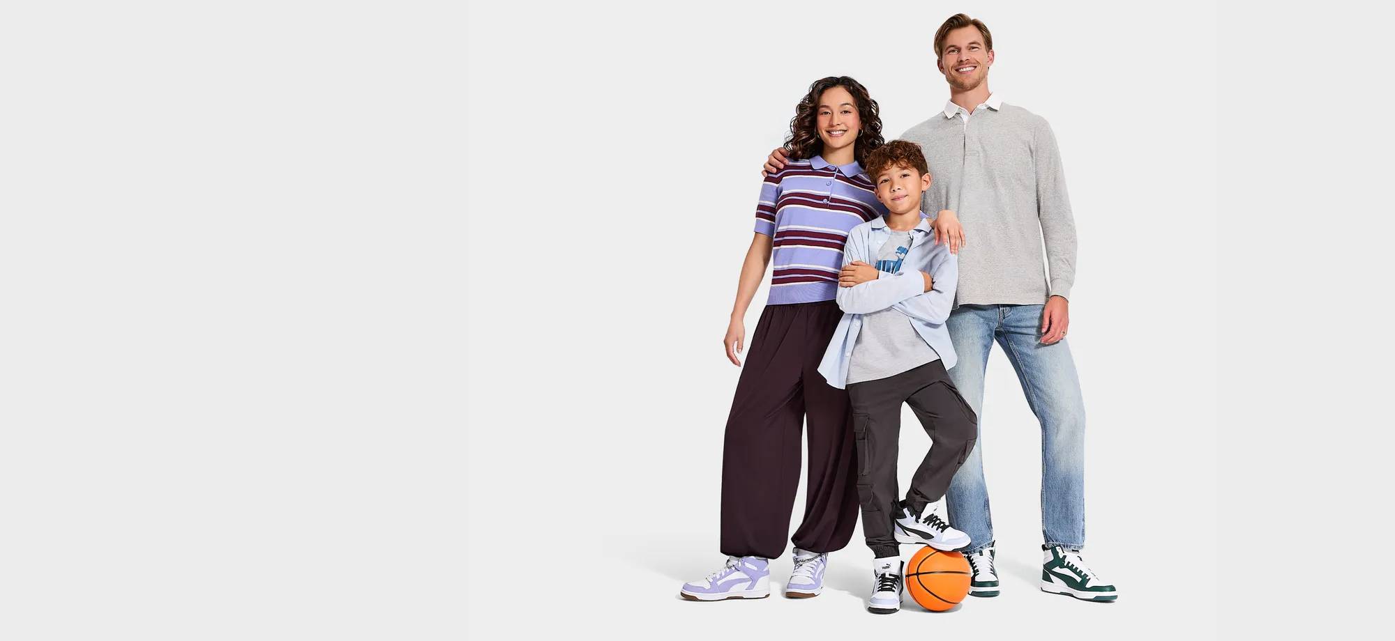 Family of 3 wearing PUMA basketball sneakers