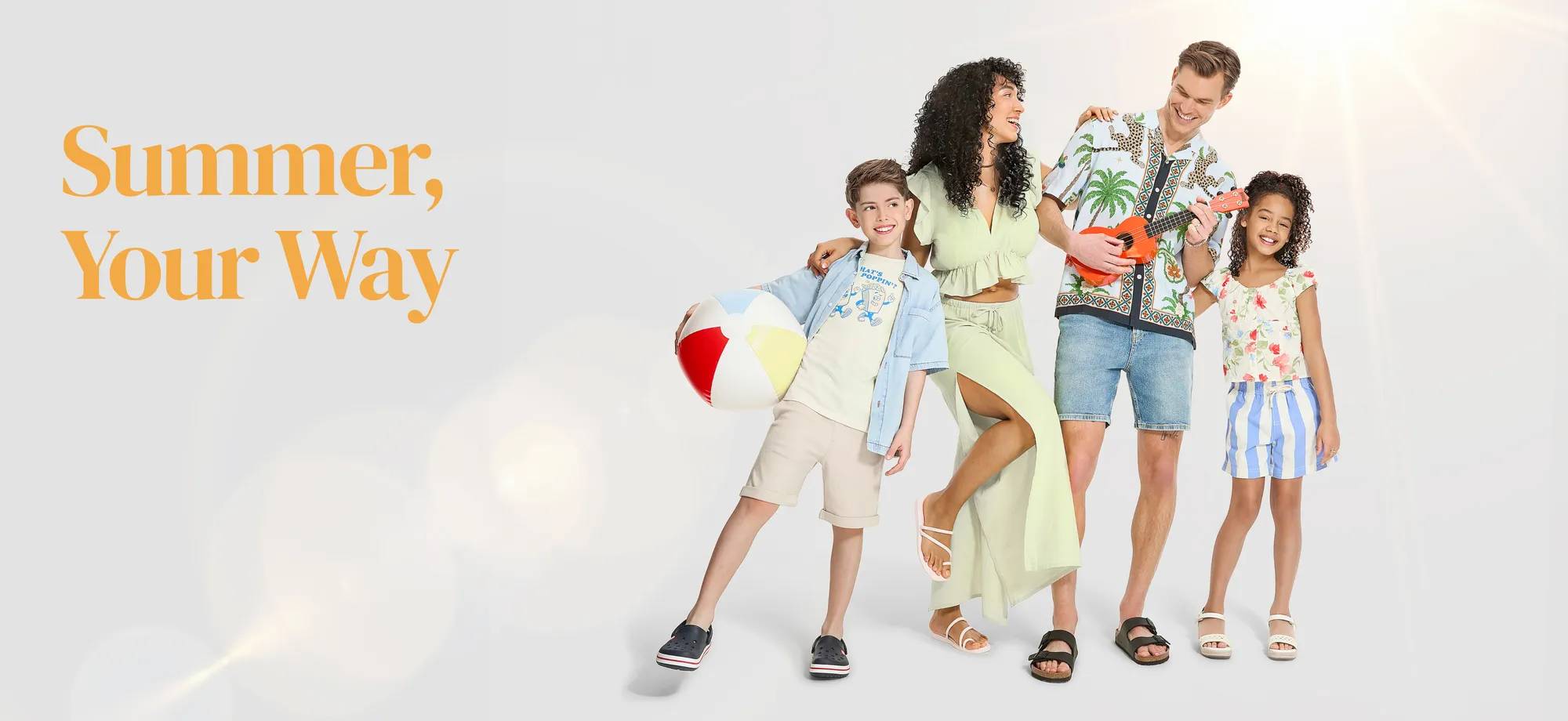 A family of 4 dressed in summer clothing and sandals