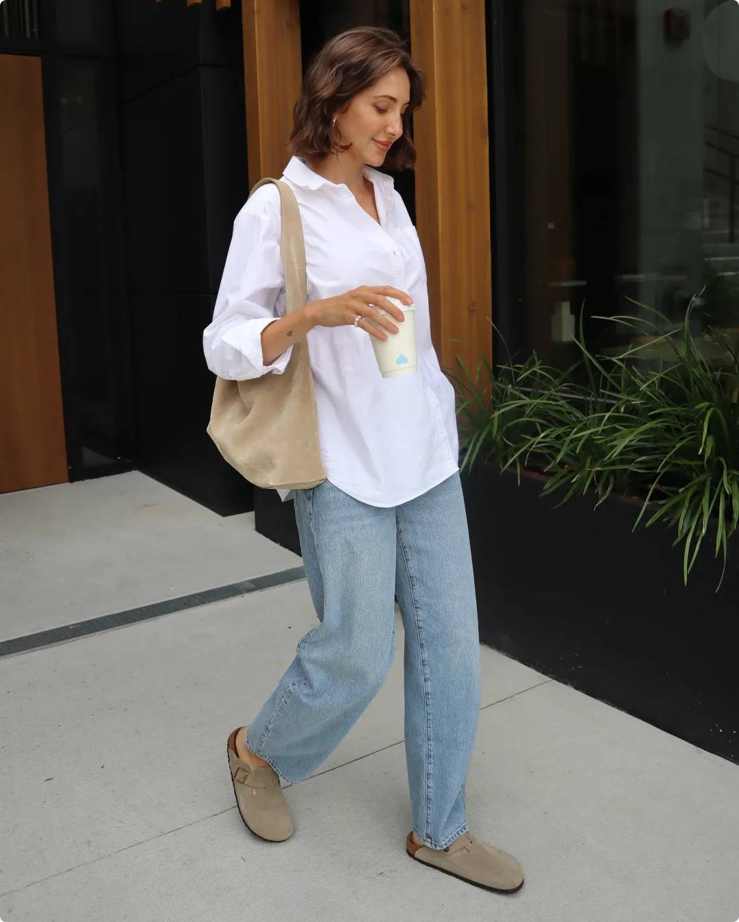 Influencer Amber Scott wearing Birkenstock shoes and holding a drink in hand
