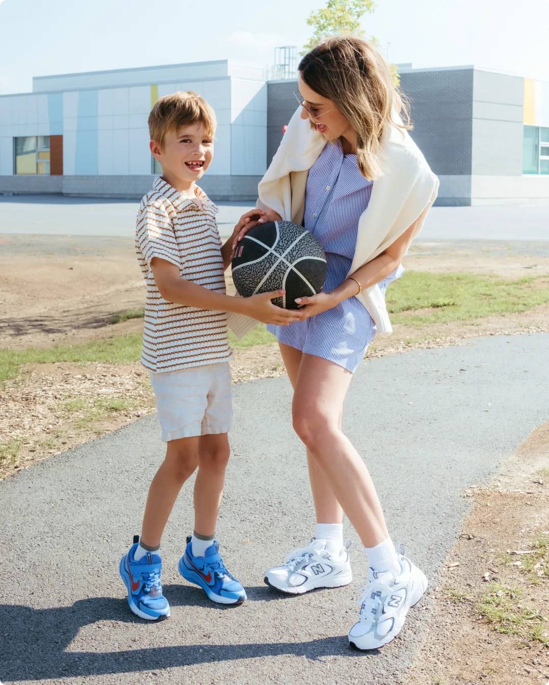 Influencer Sara Ballantyne with her son holding a basketball