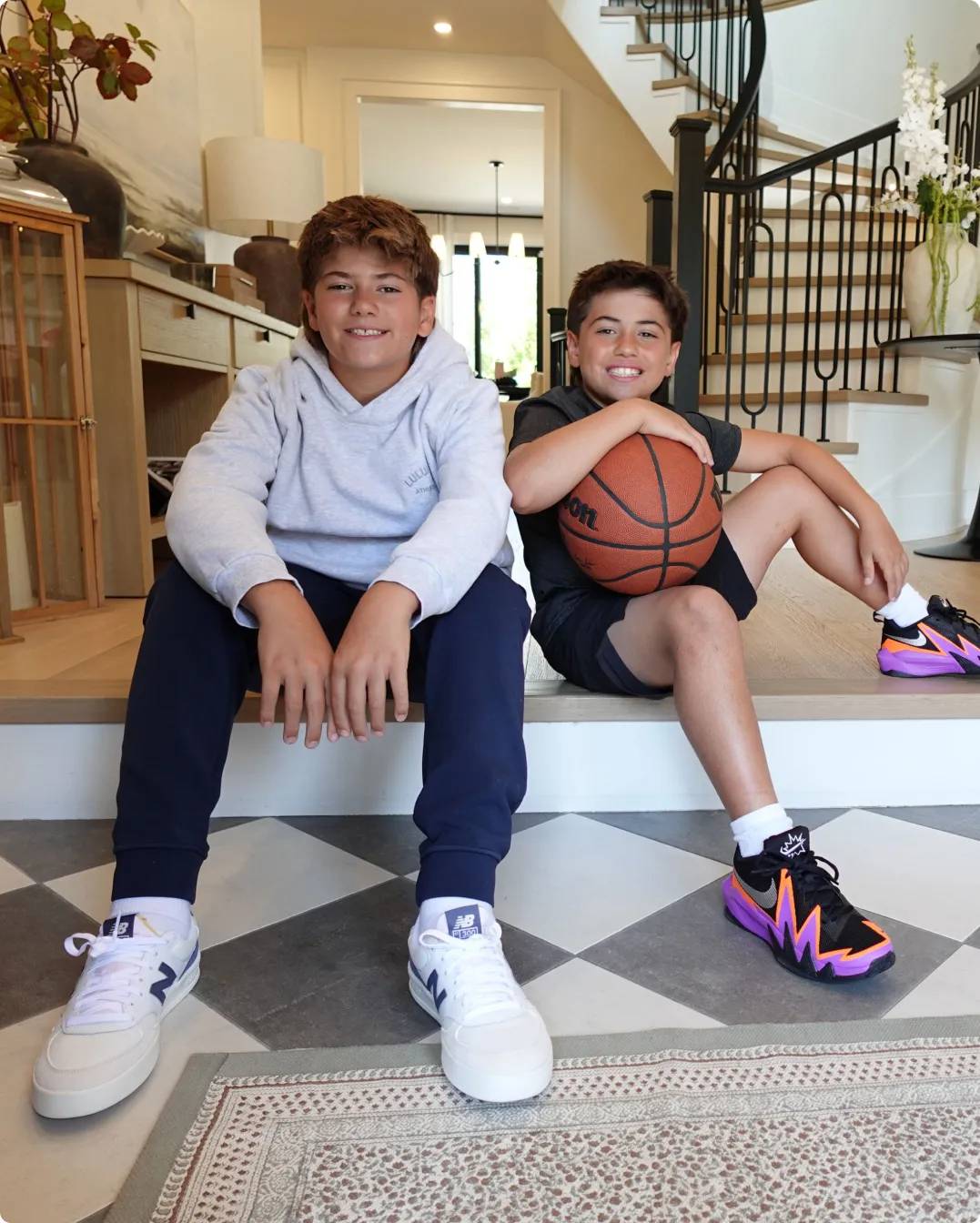 Brothers wearing sneakers and holding a basketball