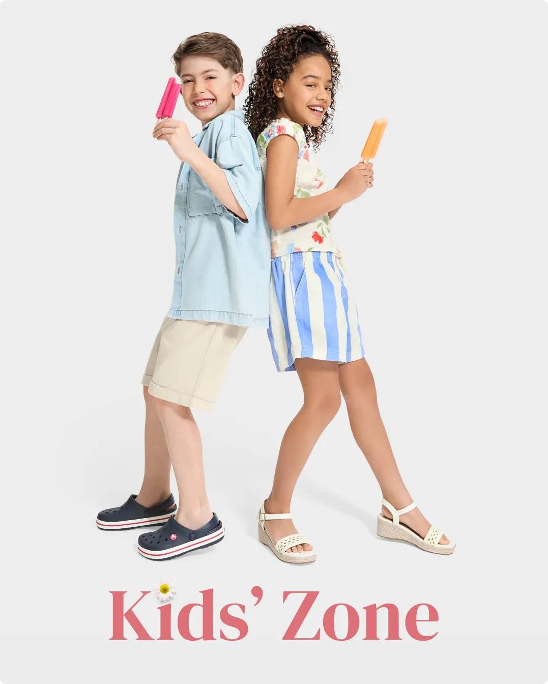 Boy and girl eating popsicles while wearing sandals