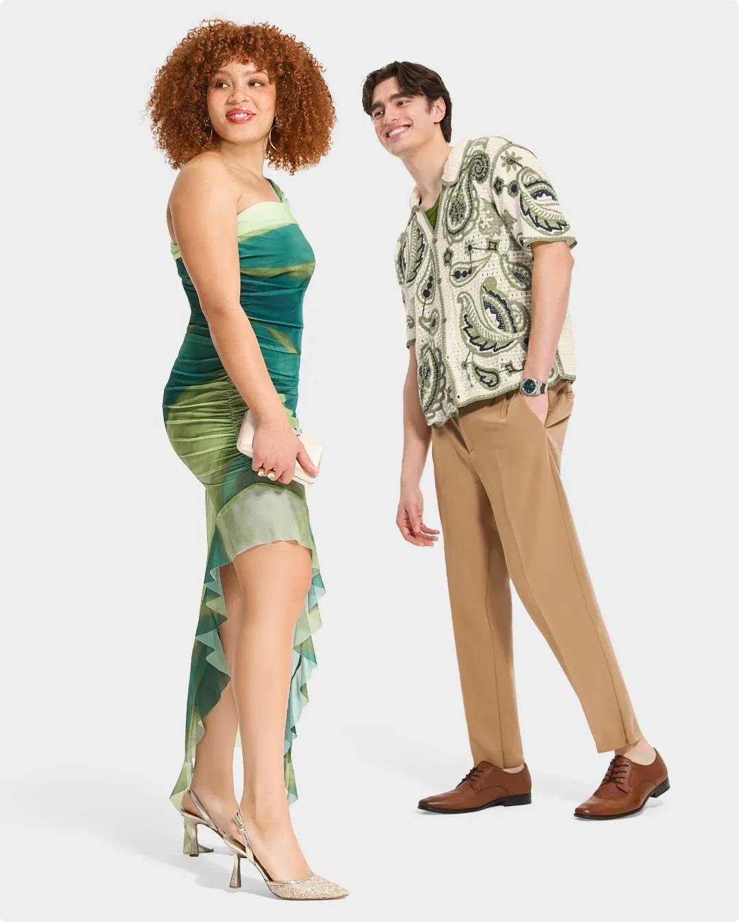 Woman wearing a green dress and heels, a man in a green pattern shirt and dress shoes