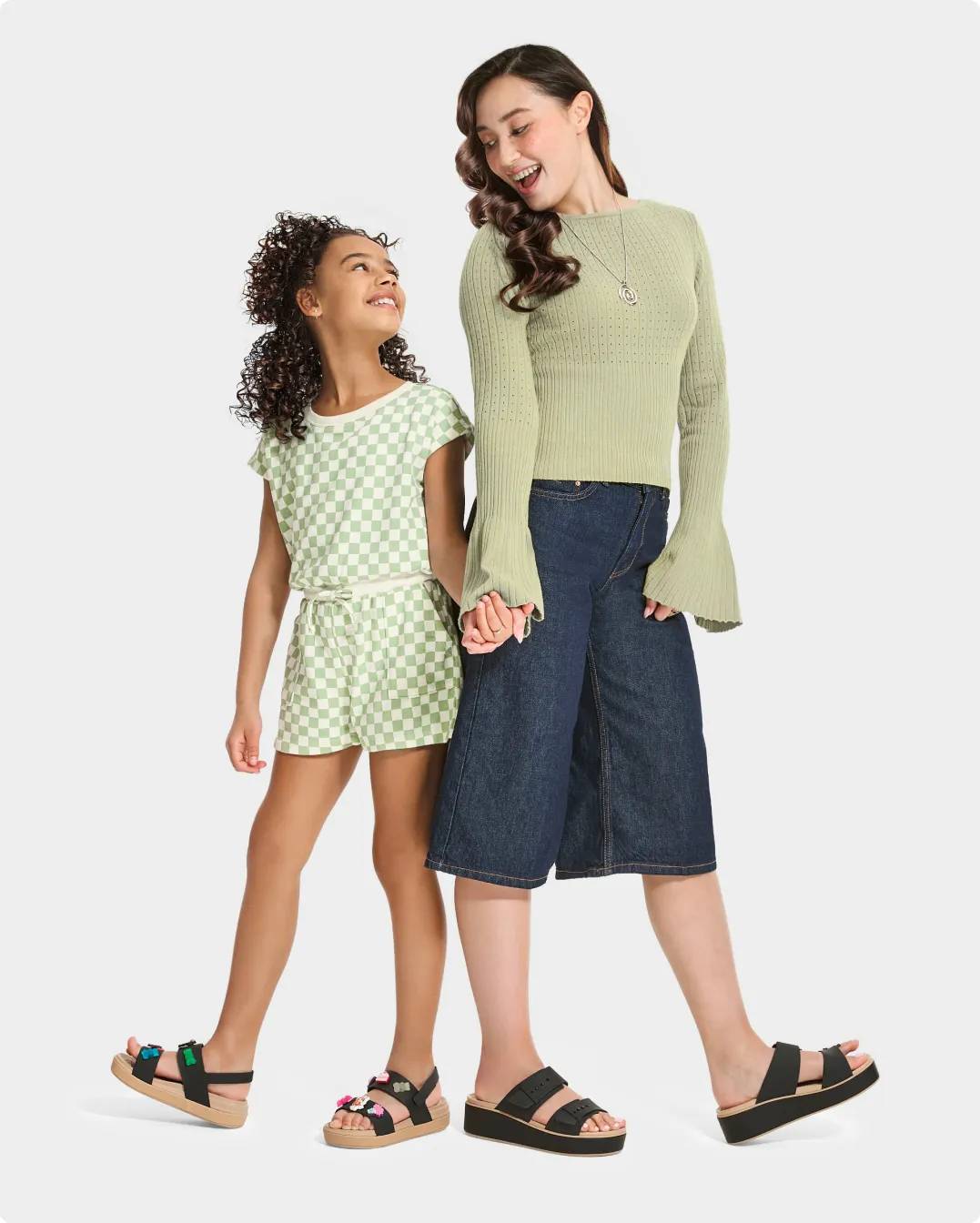 Girl and woman wearing sandals with black straps