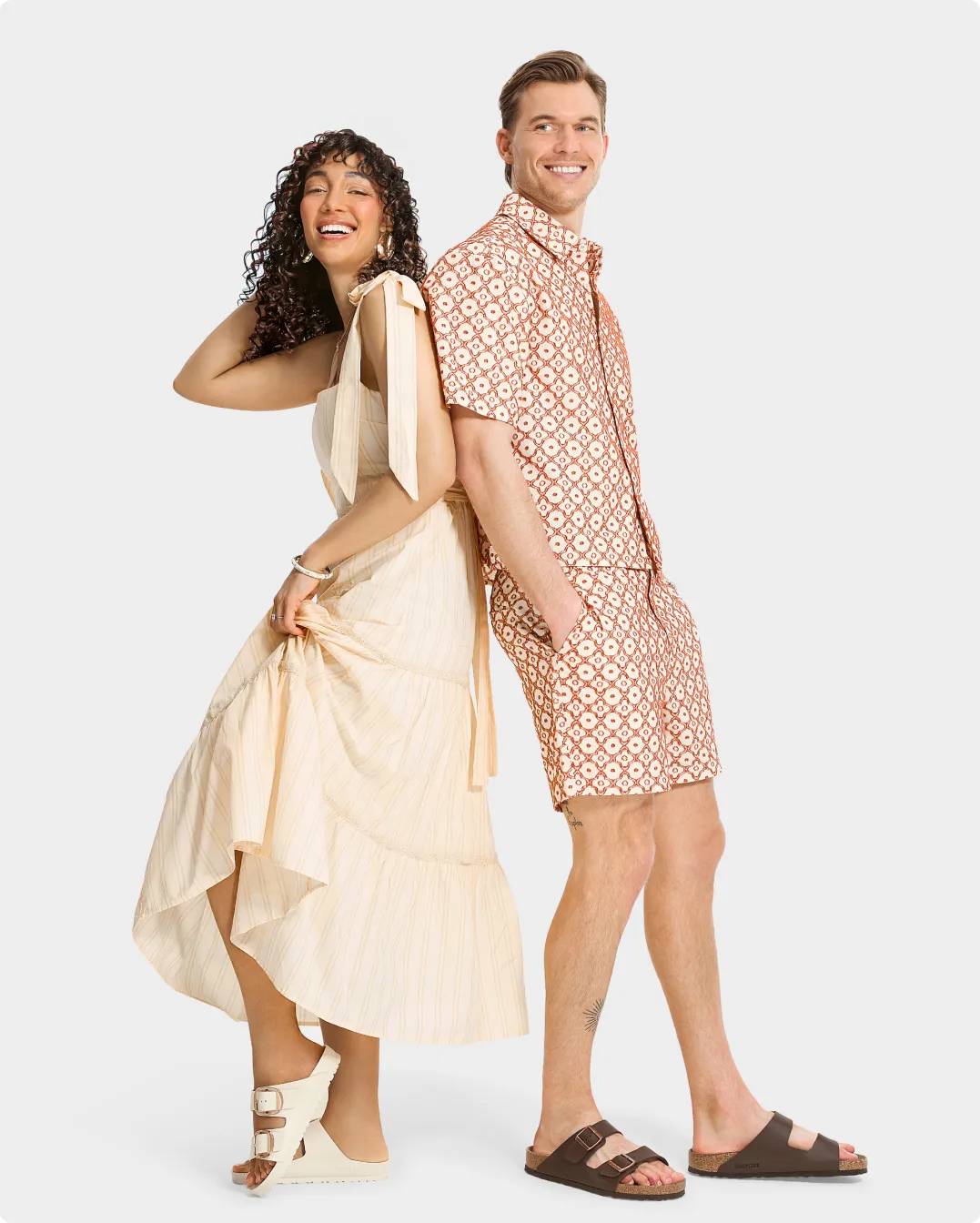 A woman in a white dress and white Birkenstock sandals, a man in a red and white outfit wearing Birkenstock sandals