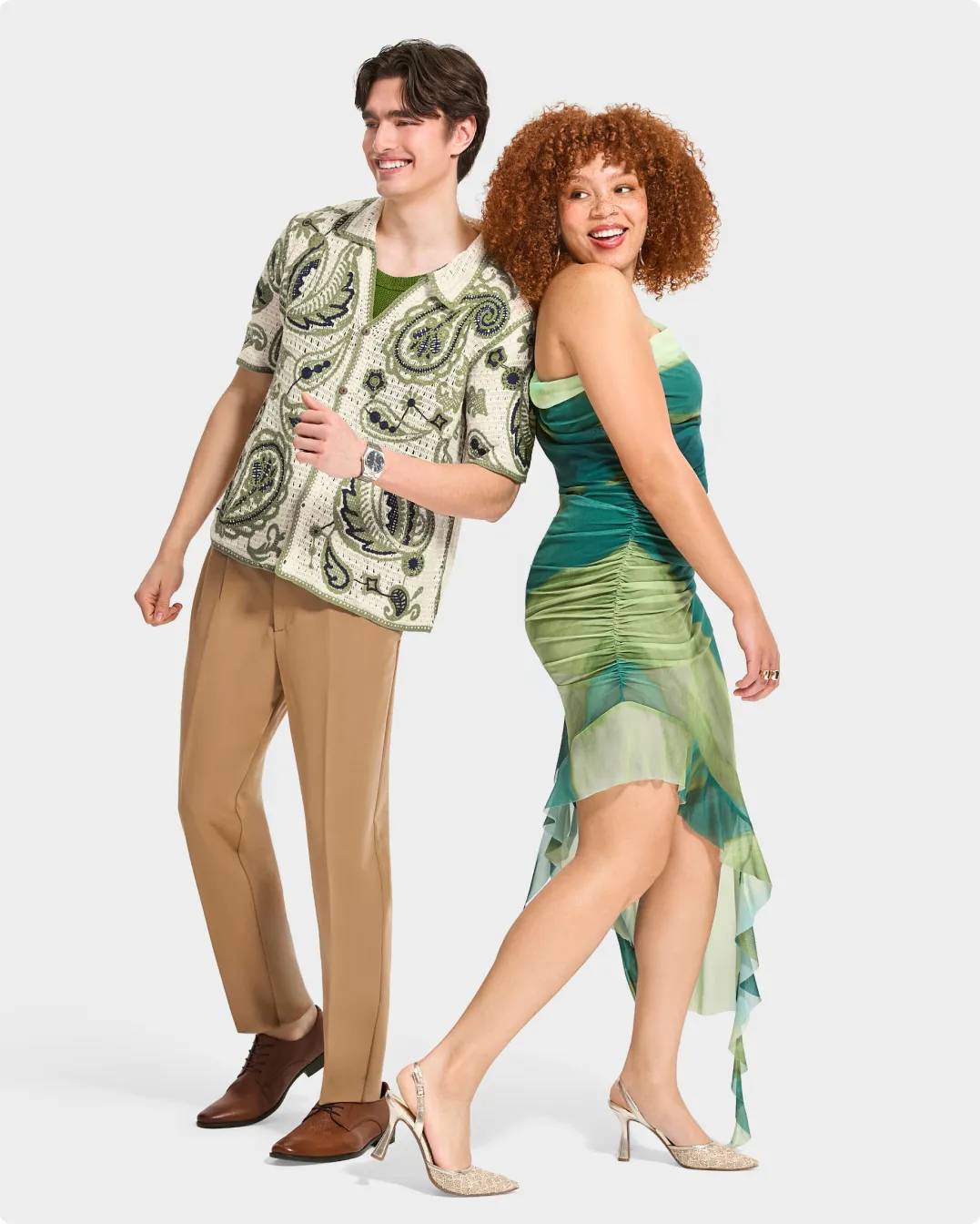 Woman wearing a green dress and heels, a man in a green pattern shirt and dress shoes
