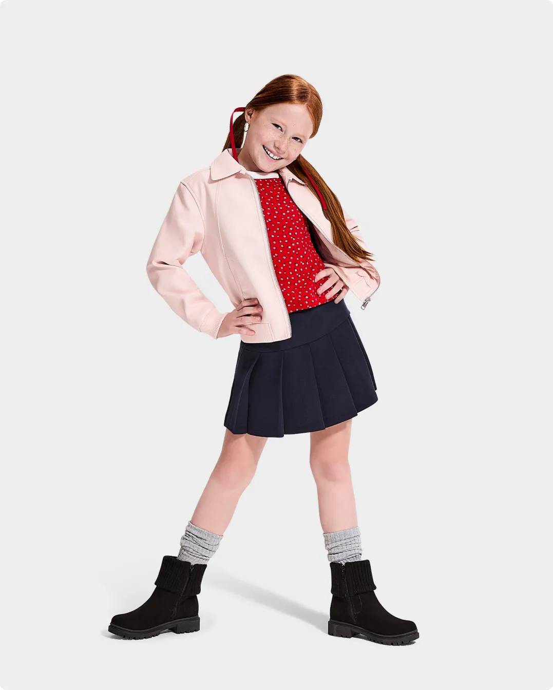A youth girl wearing fashion boots for back to school