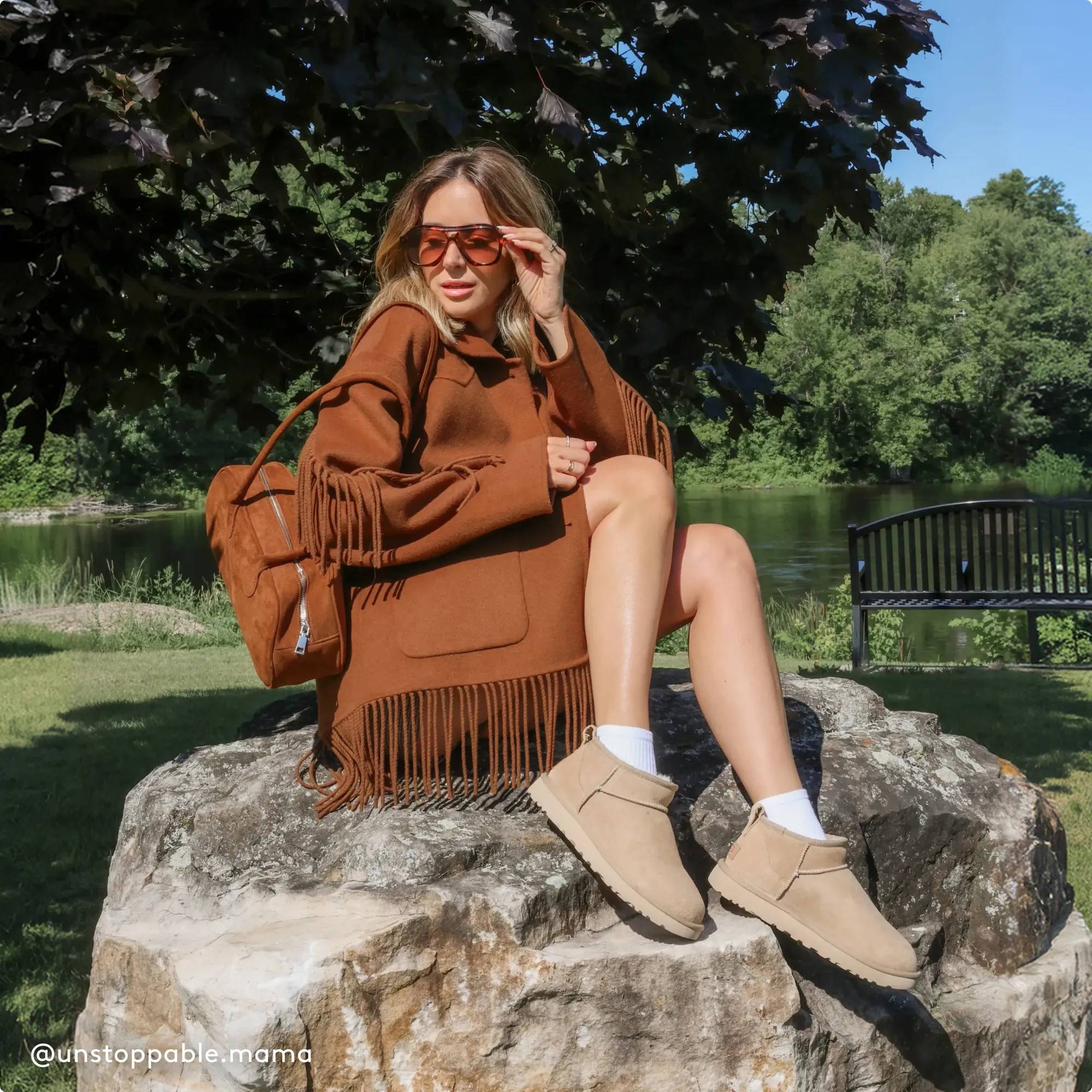Woman wearing UGGs sitting on a rock
