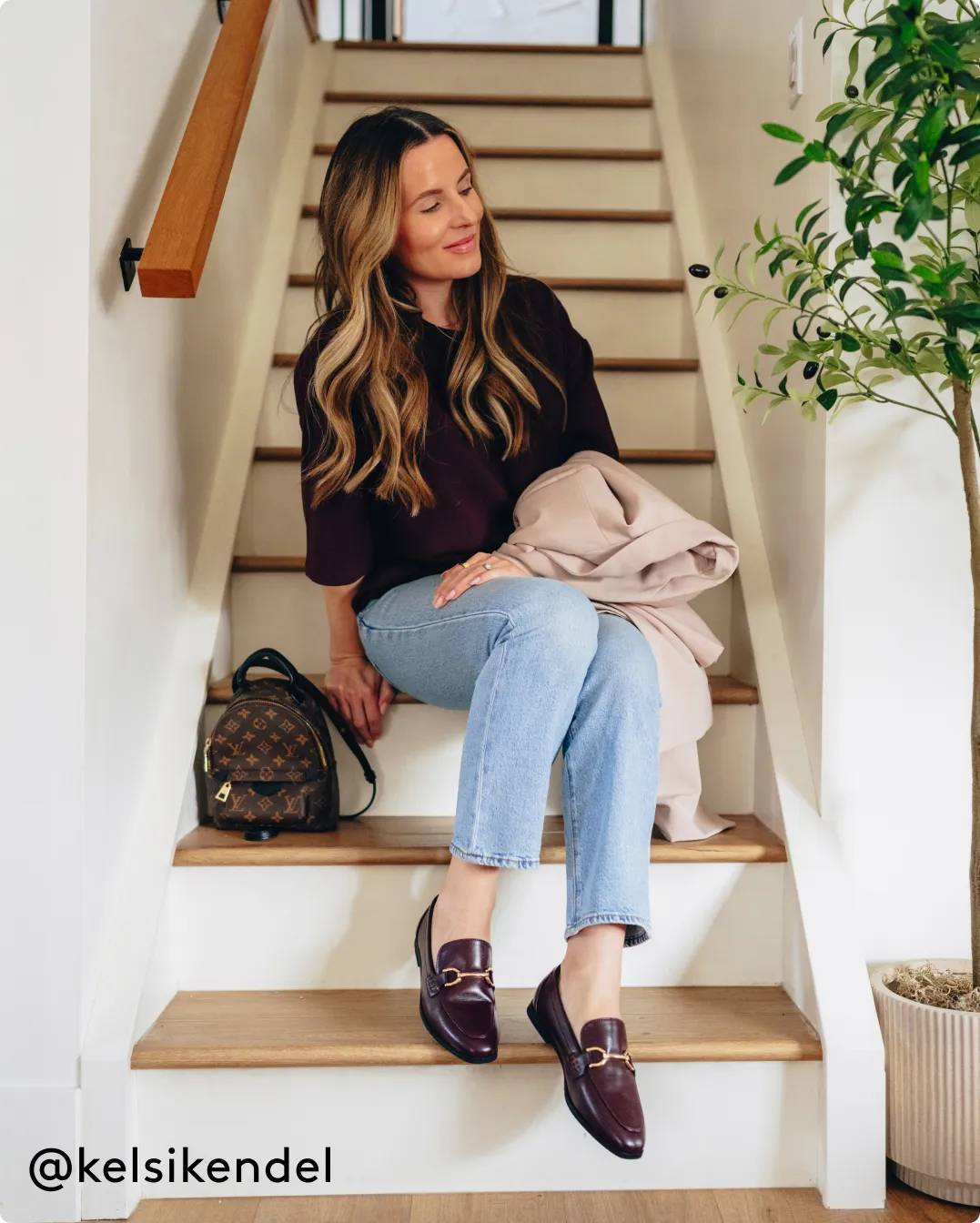 woman wearing loafers with a buckle in gold