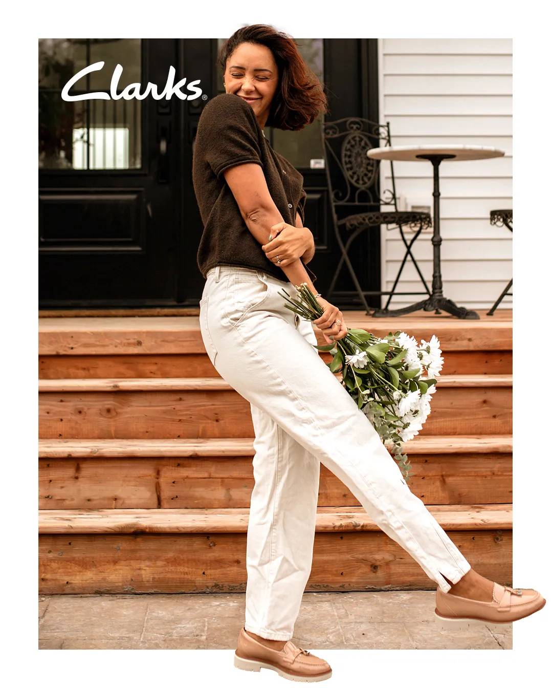 Woman in beige loafers holding a bouquet of flowers