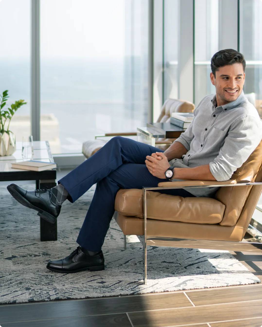 Man sitting on a chair wearing black dress shoes