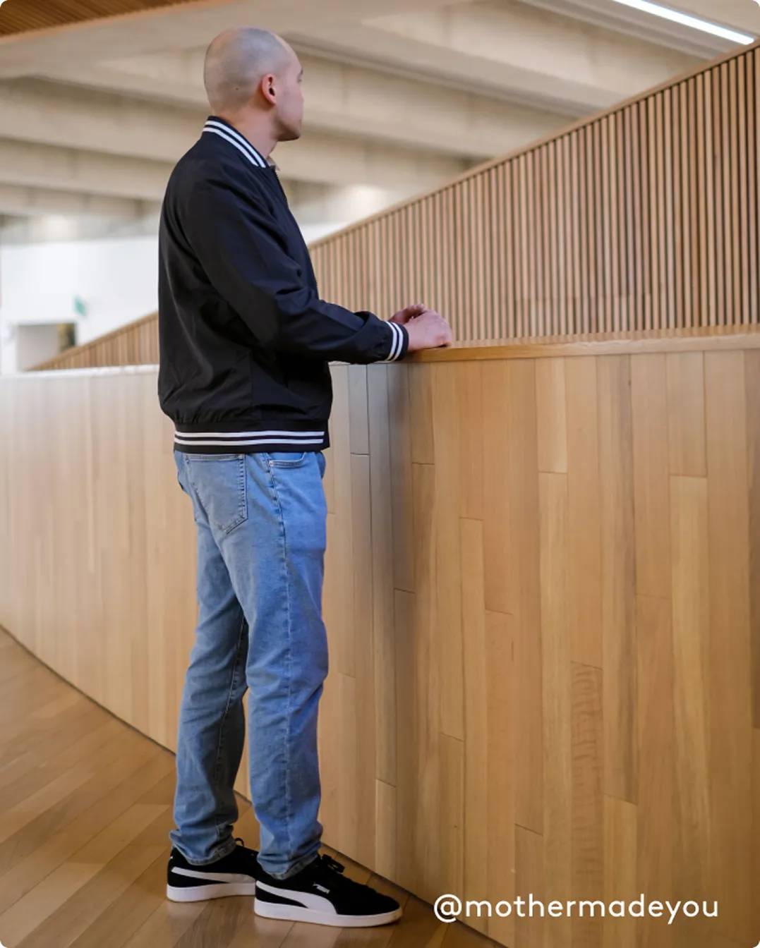 Man standing wearing black PUMA sneakers