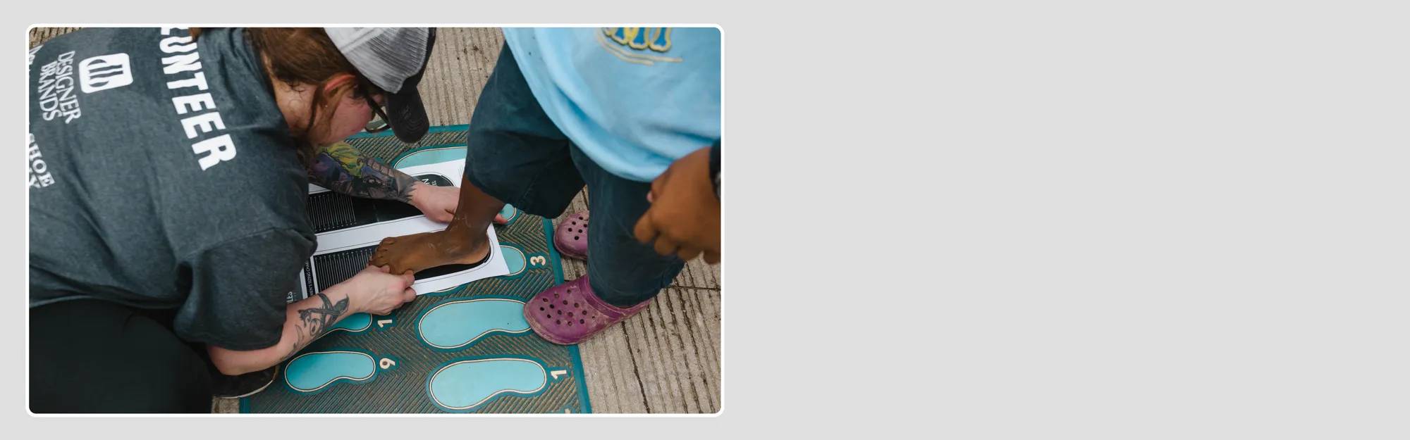 The Shoe Co. employee measuring the foot size for a person who will receive donated shoes from Soles4Souls Canada