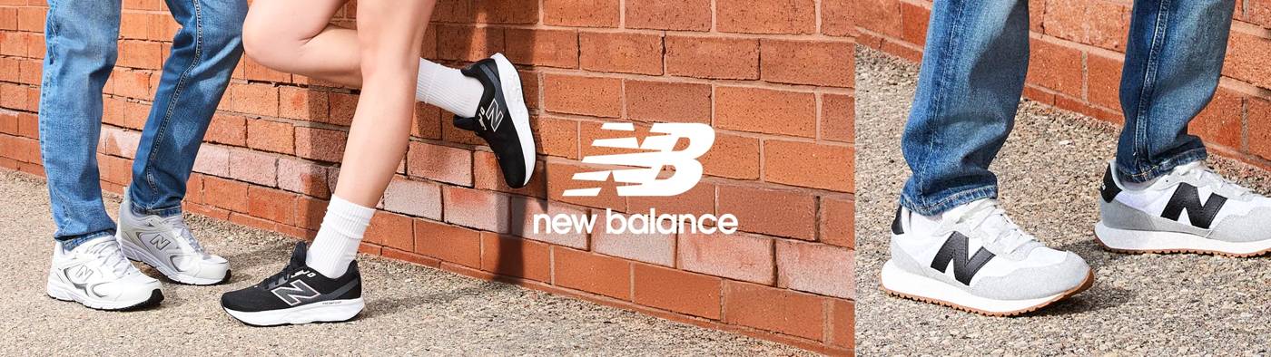 New Balance sneakers are displayed next to a brick wall