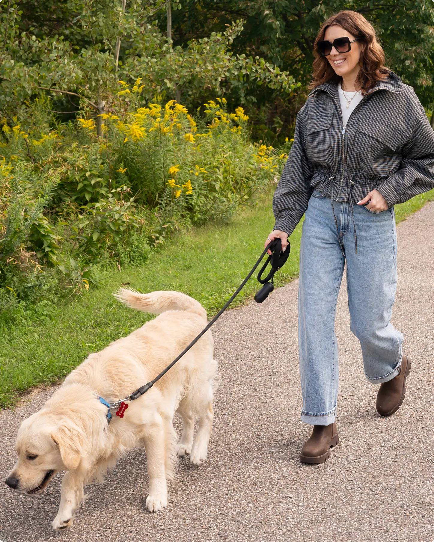 Influencer Susan Elstob wearing brown Chelsea boots walking her dog