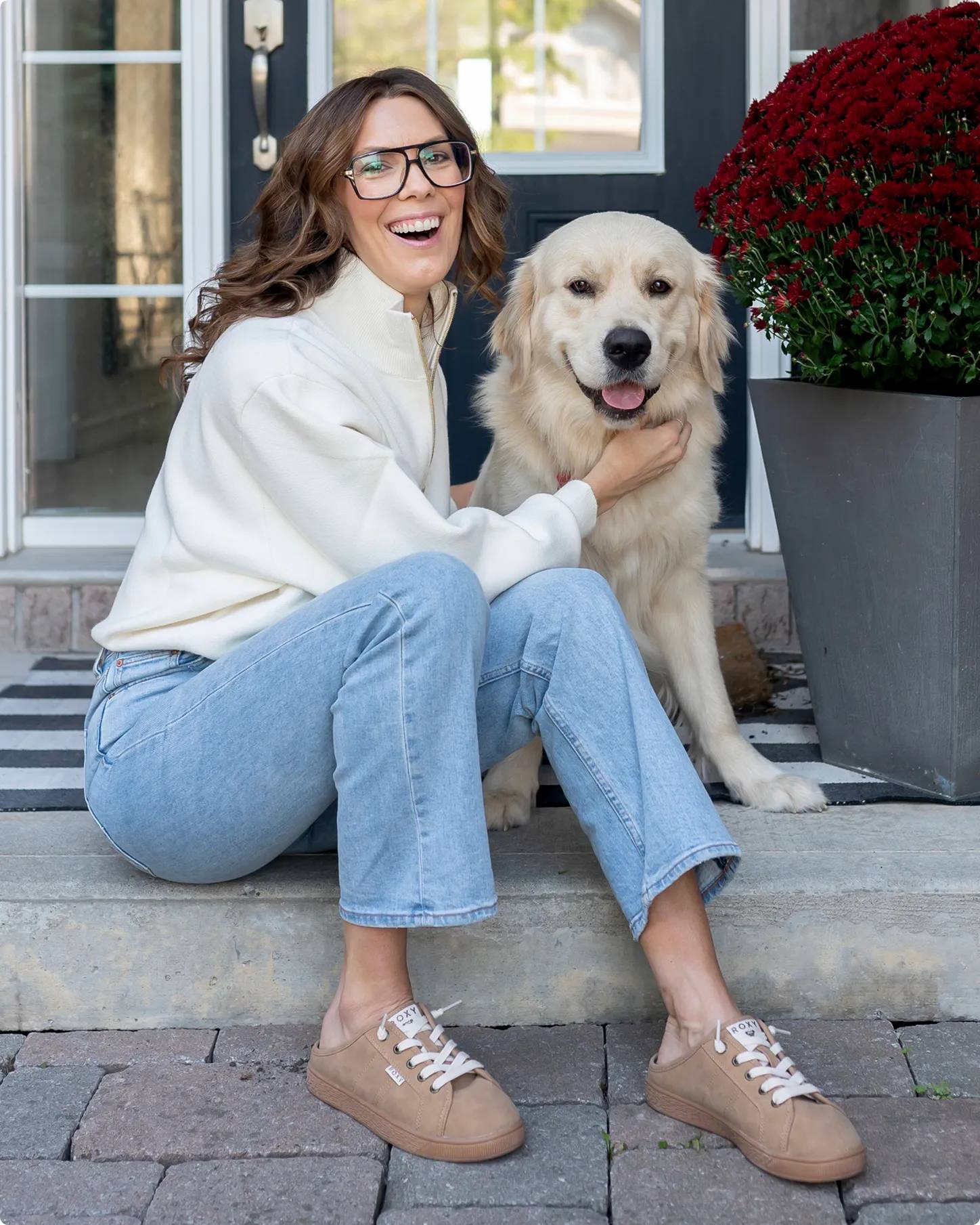 Influencer Susan Elstob wearing beige shoes petting her dog