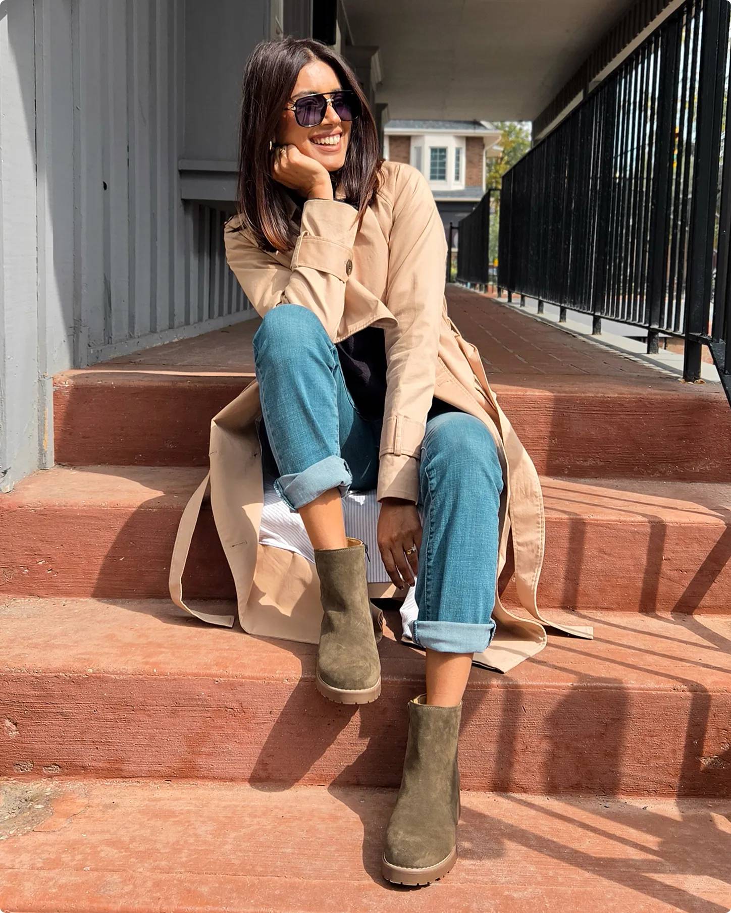 Influencer Kimberley Marquis wearing olive booties sitting on steps